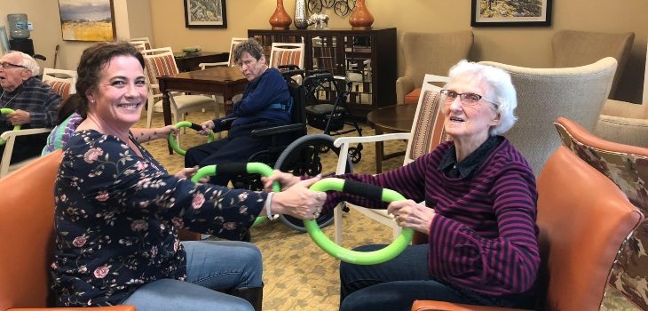 A favorite assisted living activity, Linden House team member doing smoovy exercise with resident