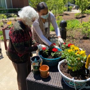 A Branchlands resident and staff member take part in container gardening