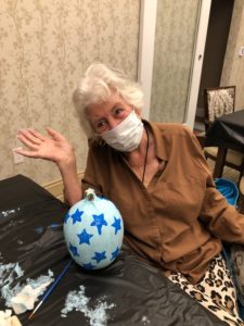 Linden House Assisted Living resident with painted Halloween pumpkin