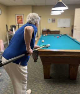 A woman playing pool