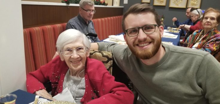Two smiling people dining and talking about senior living