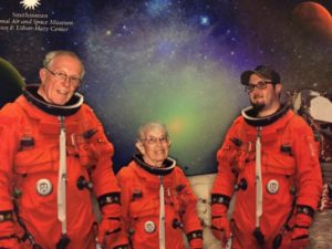 Three people in astronaut suits