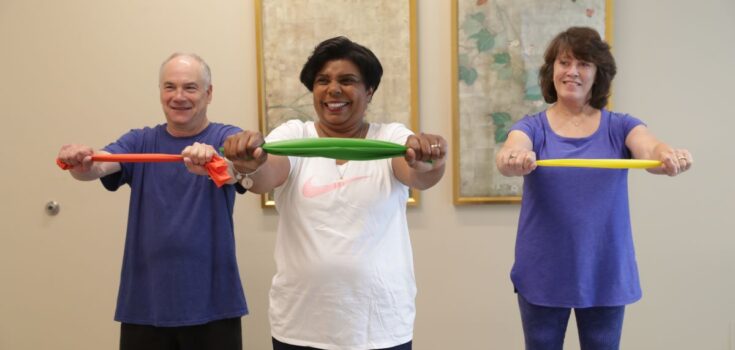 Three seniors lifting weights.