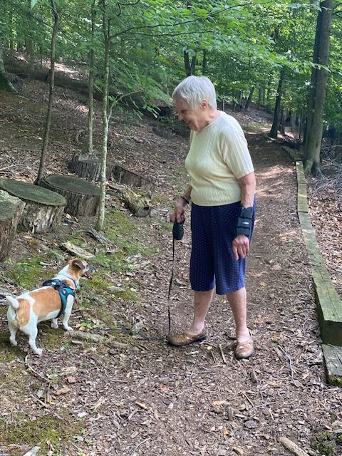 Florence and her Jack Russell terrier, Angie, on a walking trail through the woods.