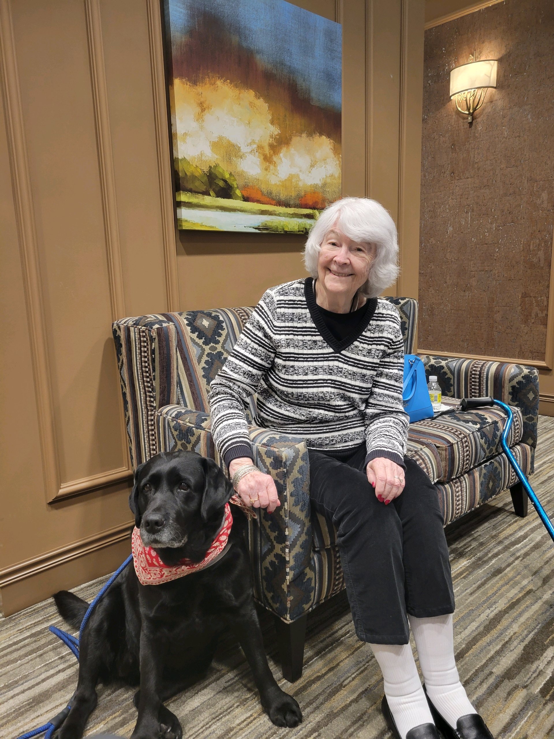 Lola the therapy dog visiting a Linden House resident.