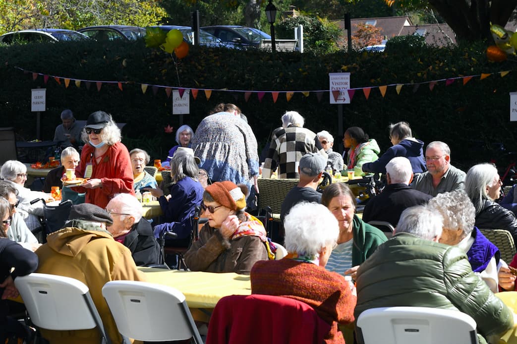 Branchlands Residents seated at tables outdoors during the 2022 Fall Festival.