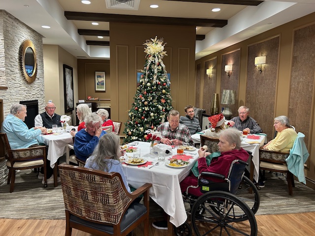 Family members join residents at a holiday dinner.