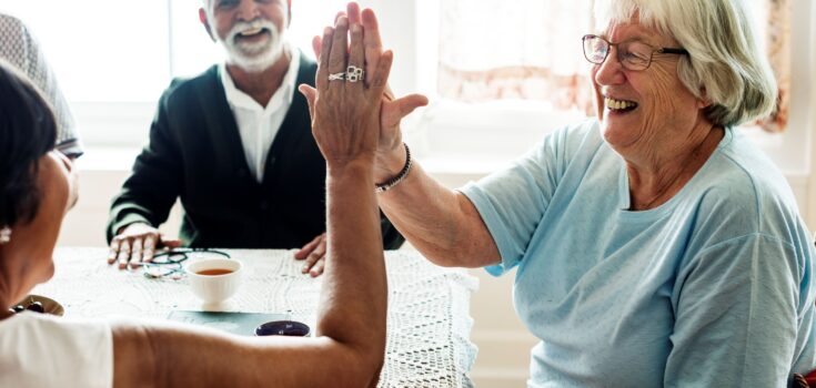 Senior women giving each other high five
